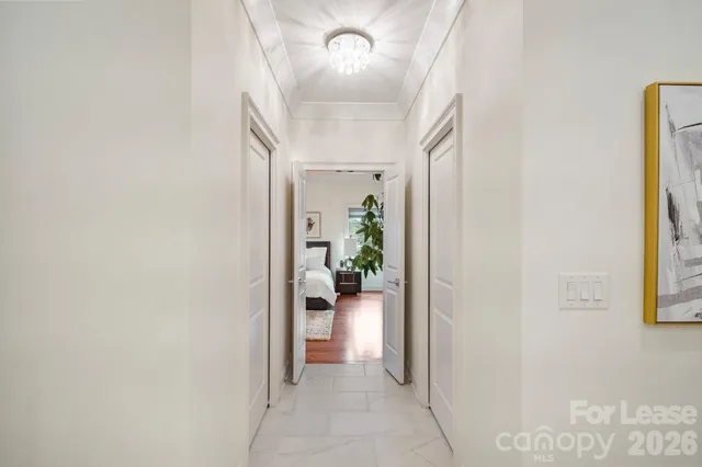 a kitchen with stainless steel appliances kitchen island granite countertop a stove a sink a refrigerator and white cabinets