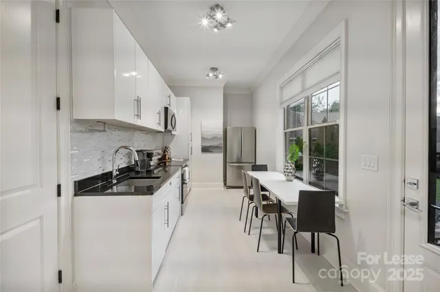 a kitchen with stainless steel appliances a stove a sink a refrigerator and cabinets