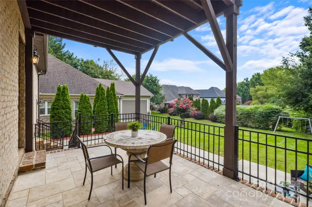 a view of a patio with a table chairs and a table