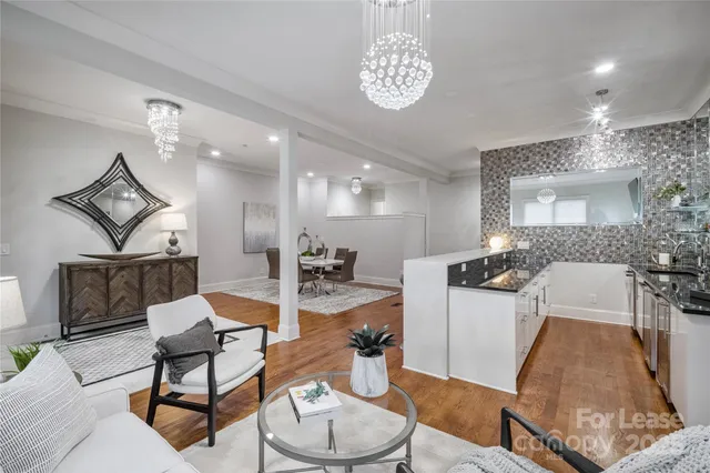 a living room with furniture a dining table and kitchen view