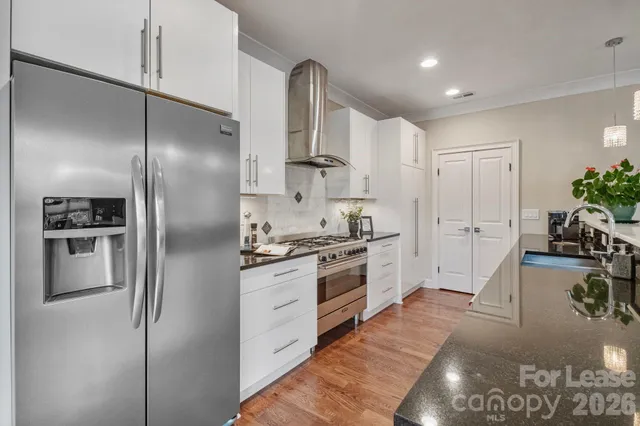 a bathroom with a granite countertop sink a toilet and shower