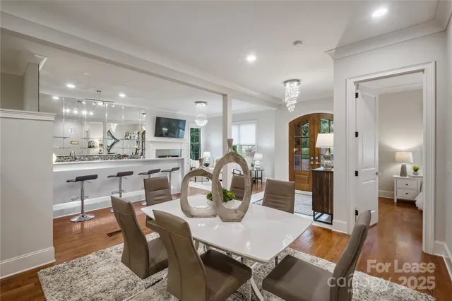 a dining room with furniture and wooden floor