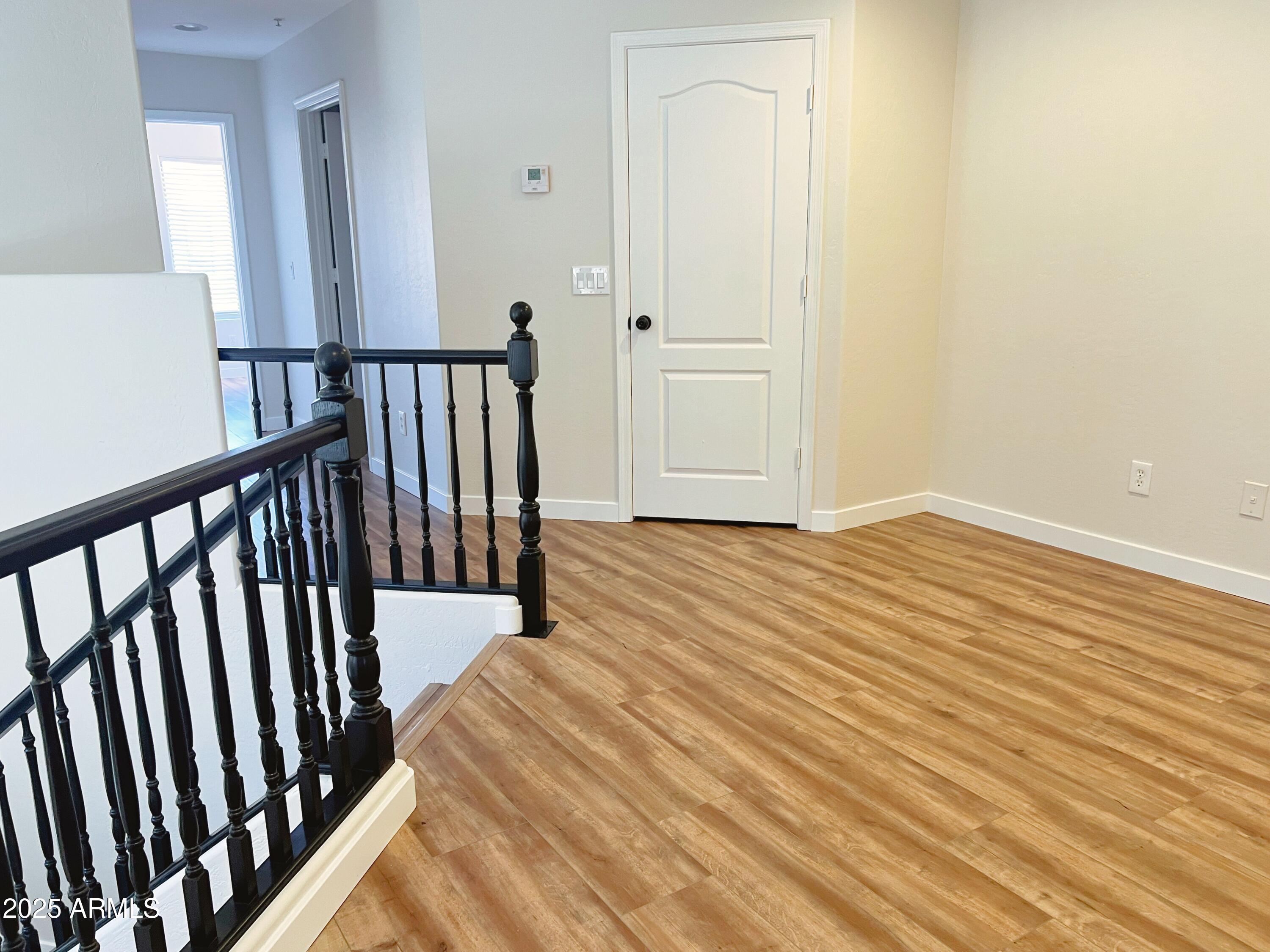 5415 East McKellips Road, Unit 90 Mesa, AZ 85215 - Photo 11 of 16 a view of a room with wooden floor and stairs