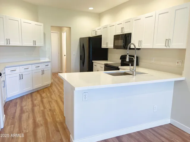 a kitchen with a sink a microwave a stove and refrigerator