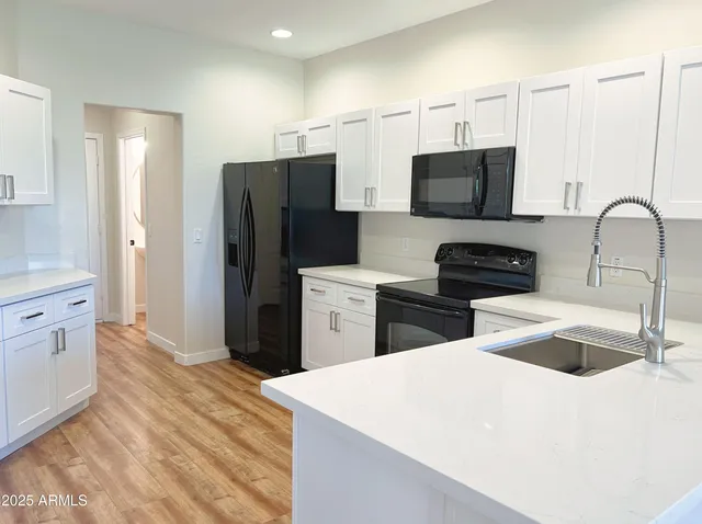 a kitchen with stainless steel appliances a refrigerator sink and microwave