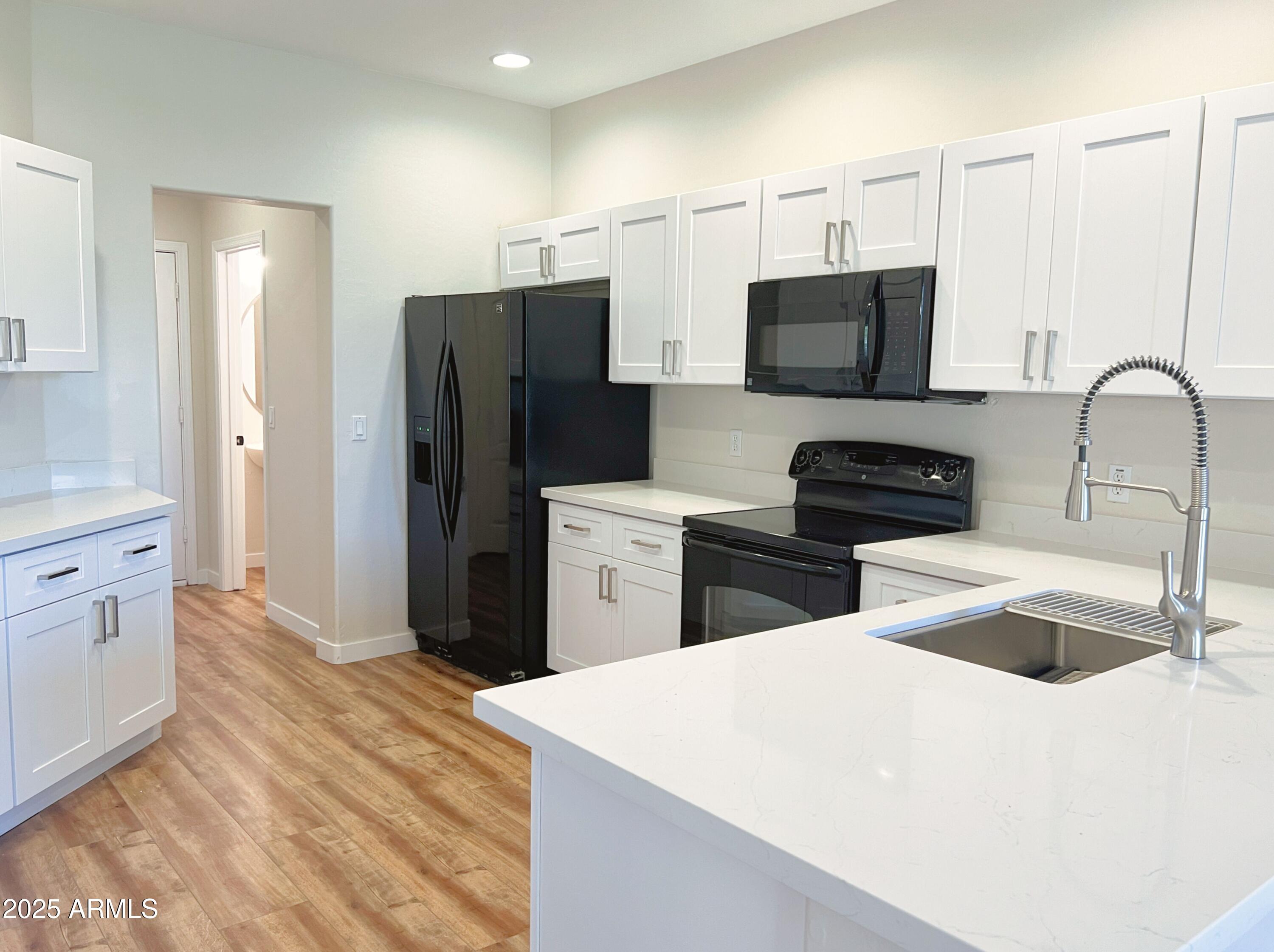 5415 East McKellips Road, Unit 90 Mesa, AZ 85215 - Photo 7 of 16 a kitchen with stainless steel appliances a refrigerator sink and microwave