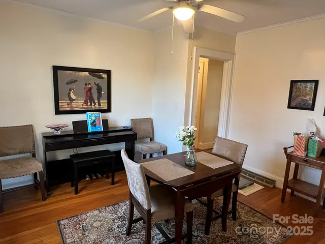 a view of a dining room with a table and chairs