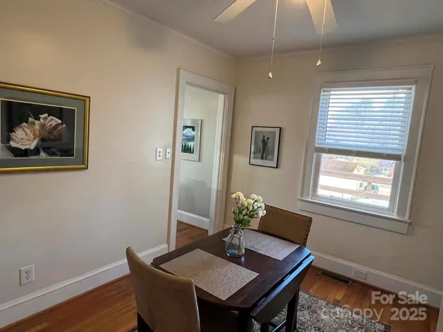 a view of a workspace with furniture and window