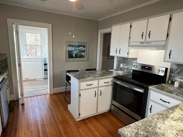a kitchen with stainless steel appliances granite countertop a stove and a refrigerator