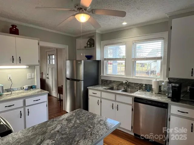 a kitchen with a sink stove and refrigerator