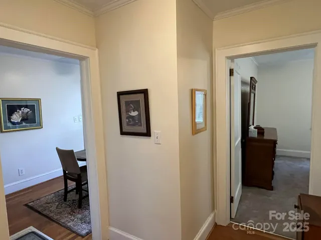 a view of a hallway with workspace and a window