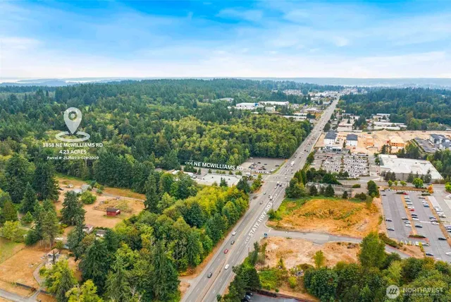an aerial view of residential houses with outdoor space and trees