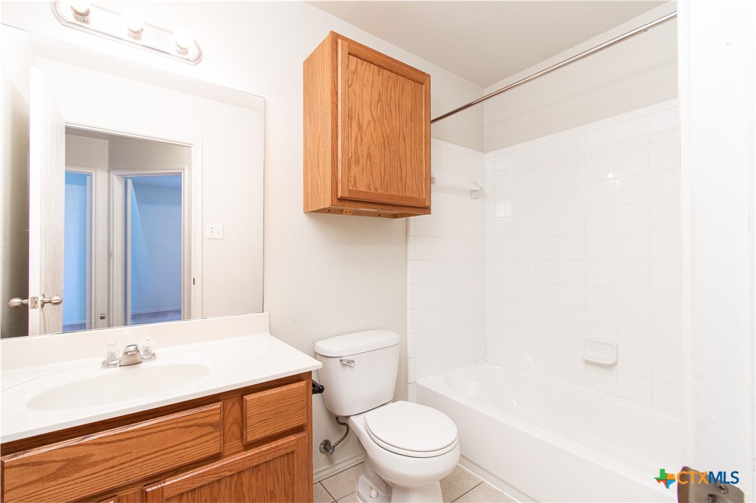 6509 Temora Loop, Unit A Killeen, TX 76549 - Photo 11 of 19 a bathroom with a sink a toilet and a mirror