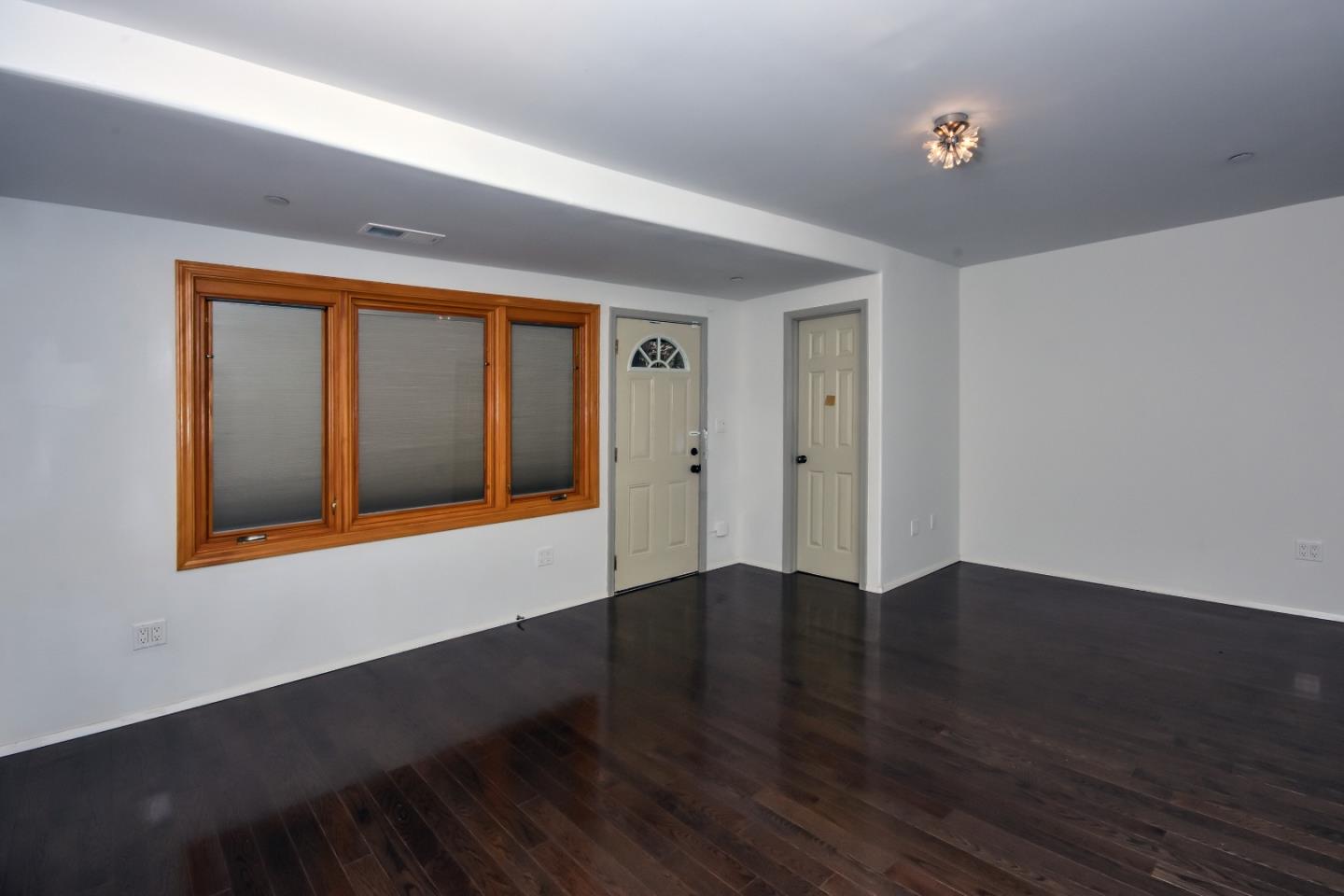 15 Anson Road Hillsborough, CA 94010 - Photo 16 of 18 a view of an empty room with wooden floor and a window