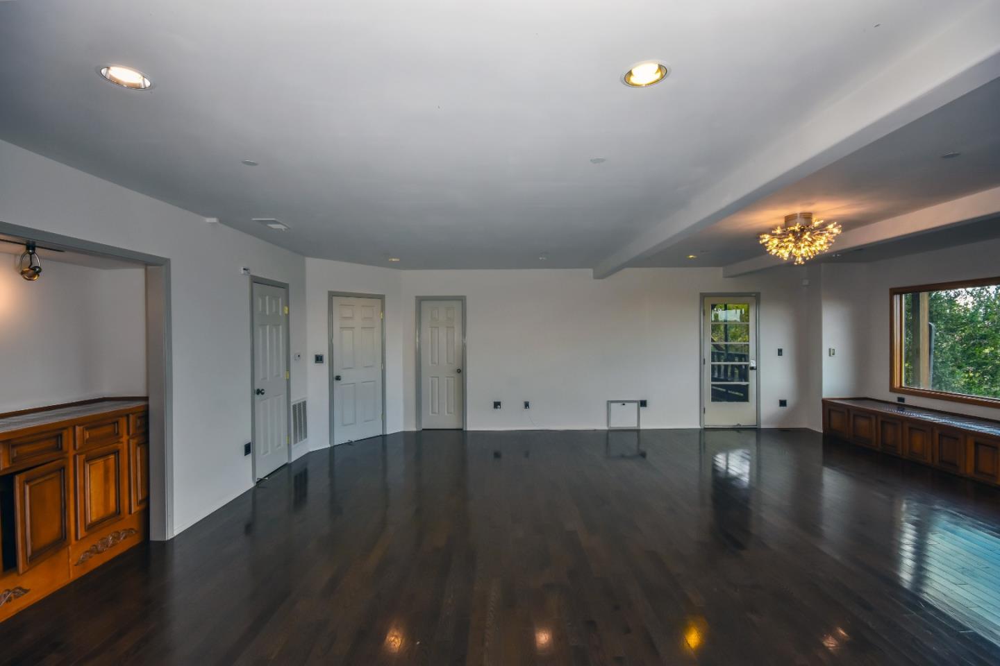 15 Anson Road Hillsborough, CA 94010 - Photo 7 of 18 a view of an empty room with wooden floor and a window