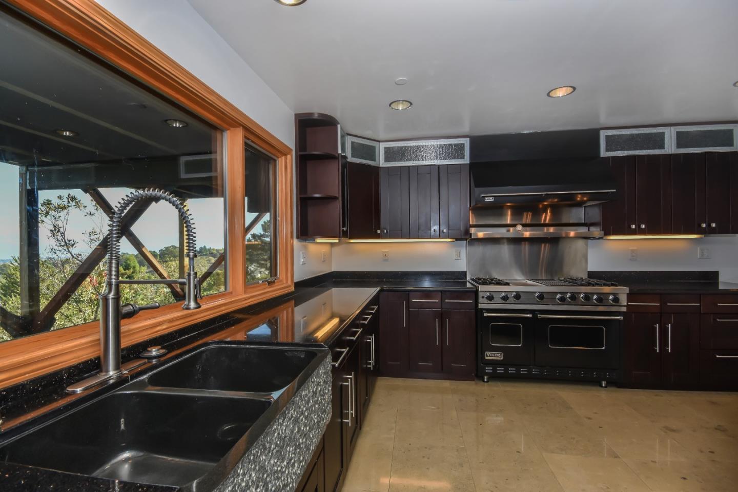 15 Anson Road Hillsborough, CA 94010 - Photo 8 of 18 a kitchen with stainless steel appliances kitchen island granite countertop a stove and a sink