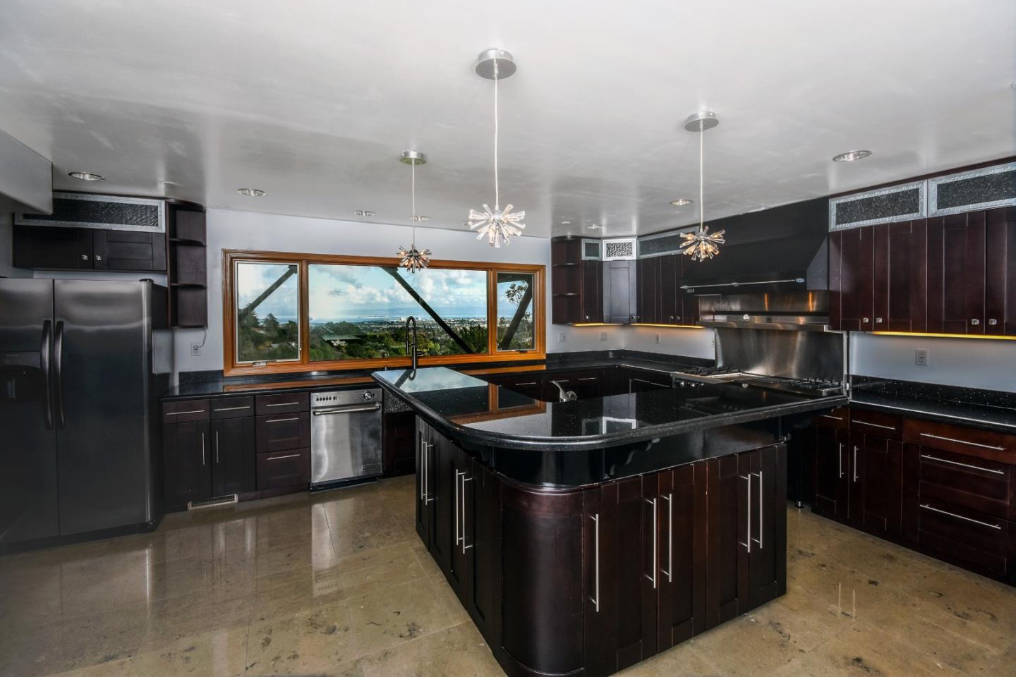 15 Anson Road Hillsborough, CA 94010 - Photo 9 of 18 a kitchen with stainless steel appliances granite countertop a sink stove and refrigerator