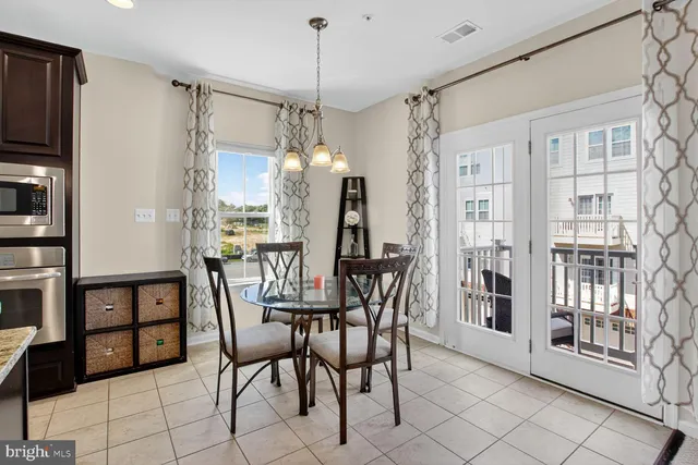 a view of a dining room with furniture and chandelier