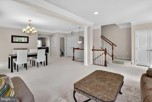 a living room with furniture and a dining table