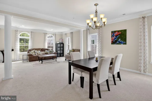 a living room with furniture a chandelier and a flat screen tv
