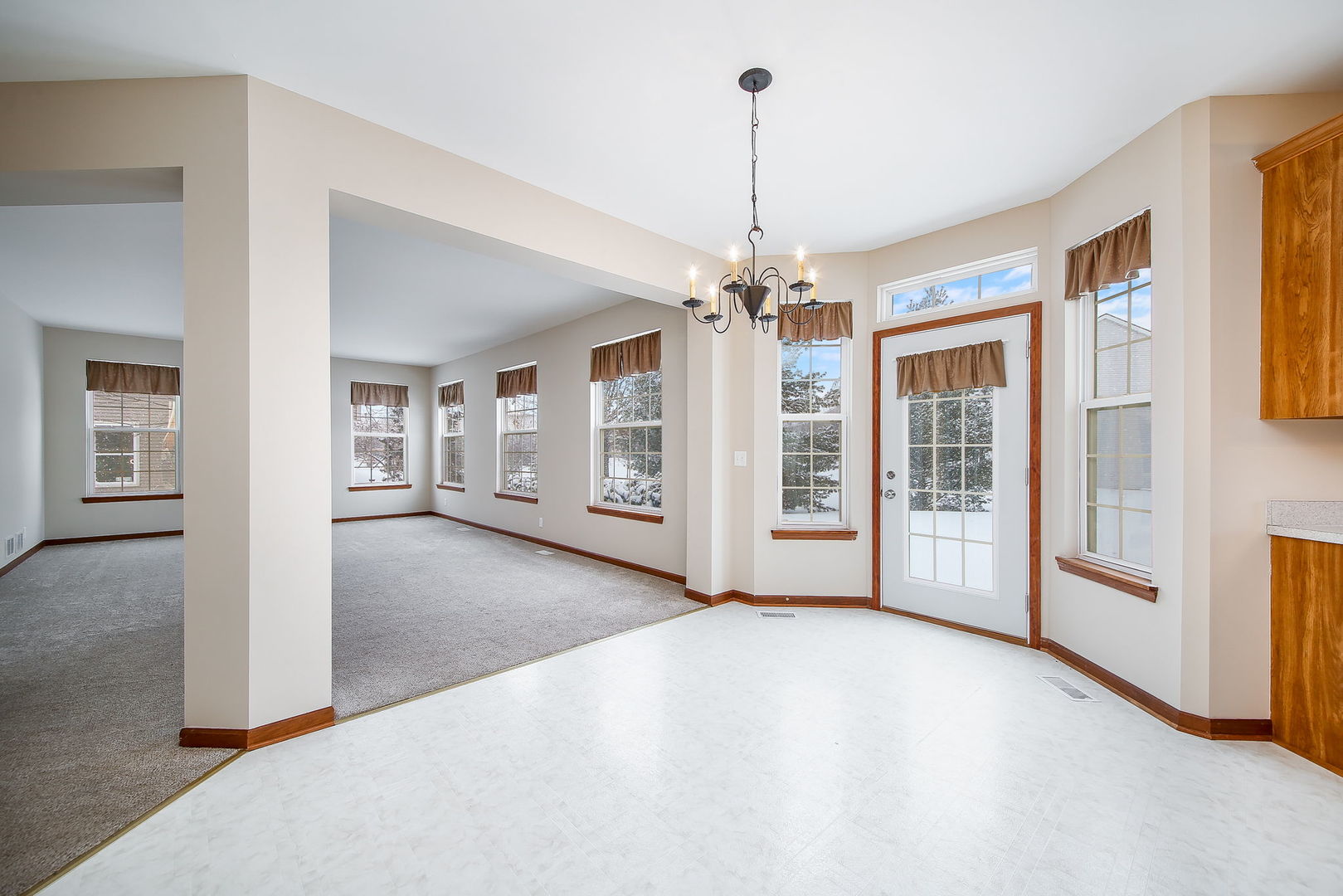 745 Boyce Road Sugar Grove, IL 60554 - Photo 7 of 38 a view of a livingroom with a chandelier fireplace and windows