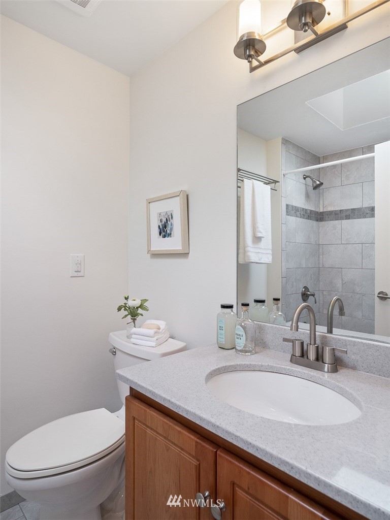 18 199th Place Southeast Bothell, WA 98012 - Photo 19 of 23 a bathroom with a granite countertop toilet sink and mirror