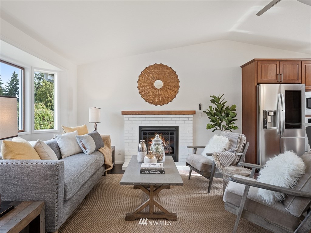 18 199th Place Southeast Bothell, WA 98012 - Photo 5 of 23 a living room with furniture a fireplace and a large window