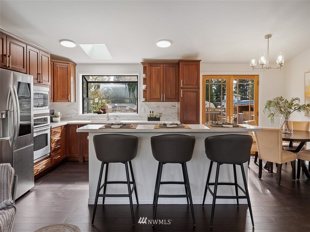 18 199th Place Southeast Bothell, WA 98012 - Photo 7 of 23 a kitchen with a table chairs refrigerator and cabinets