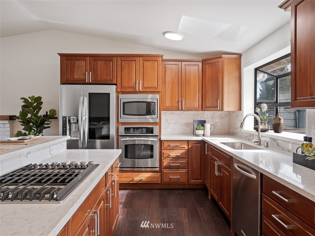 18 199th Place Southeast Bothell, WA 98012 - Photo 9 of 23 a kitchen with stainless steel appliances a stove sink and cabinets
