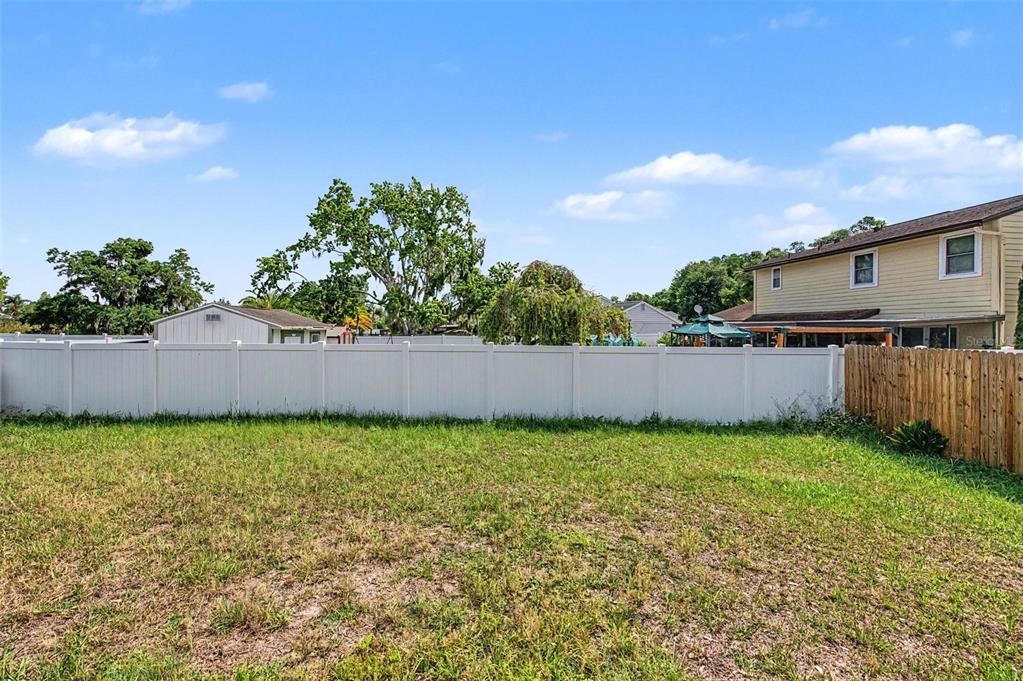 1632 Pintail Court Lutz, FL 33549 - Photo 28 of 34 a view of a yard with wooden fence