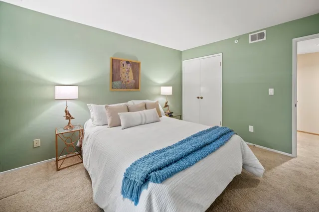 a bed room with a bed and a night lamp