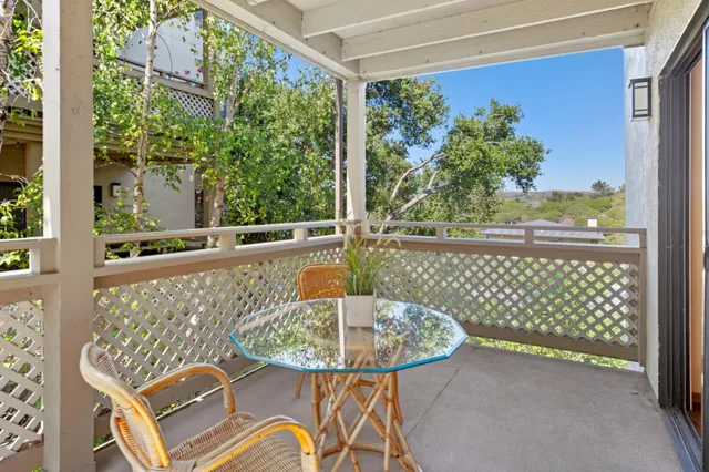 a view of a balcony with table and chairs
