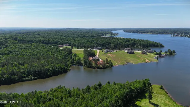an aerial view of a house with yard swimming pool and outdoor seating