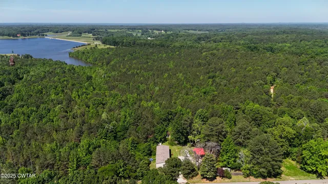 an aerial view of a houses with a yard