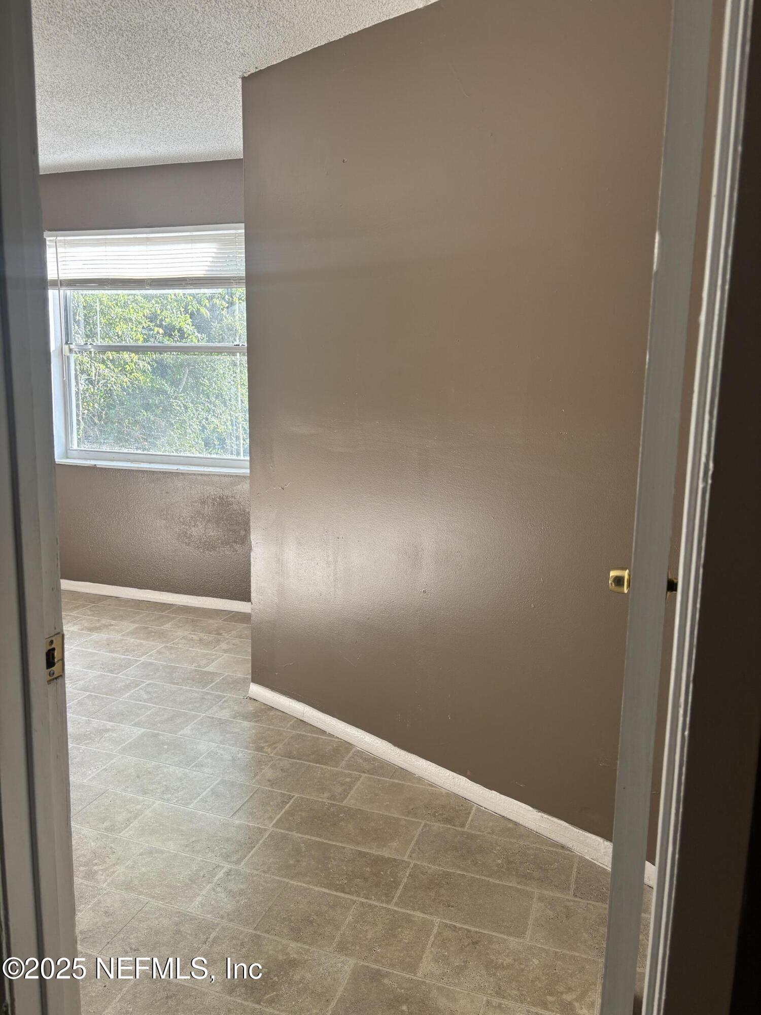 1115 Rushing Street Jacksonville, FL 32209 - Photo 13 of 24 an empty room with a window