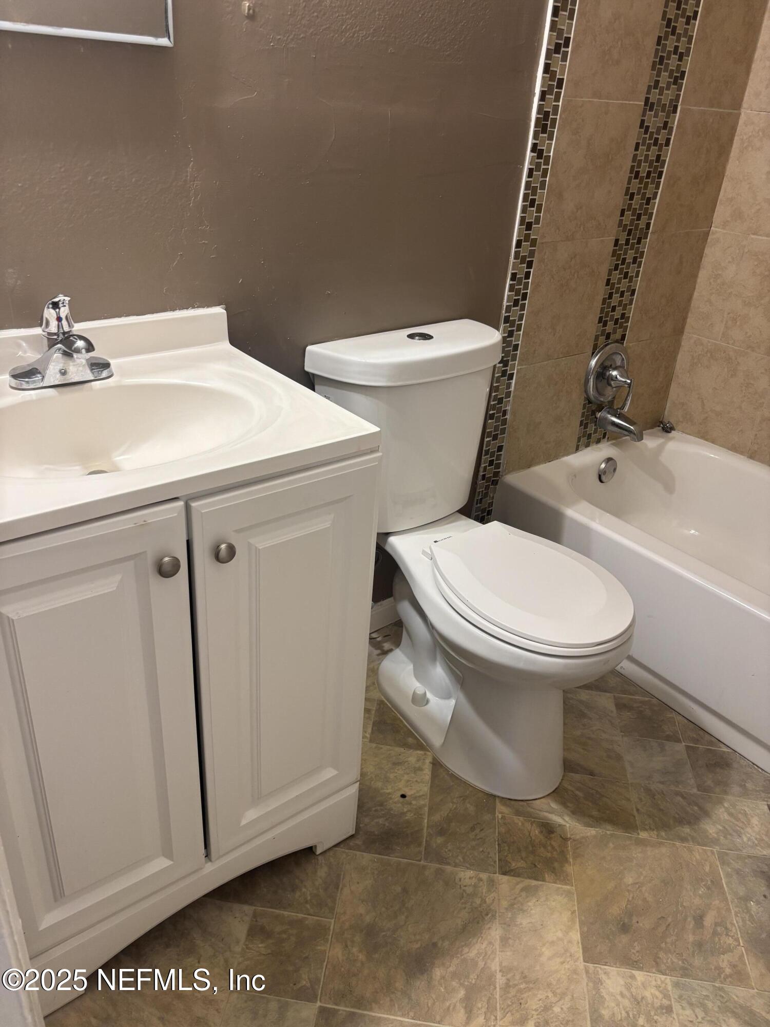 1115 Rushing Street Jacksonville, FL 32209 - Photo 18 of 24 a white toilet sitting next to a bathroom sink