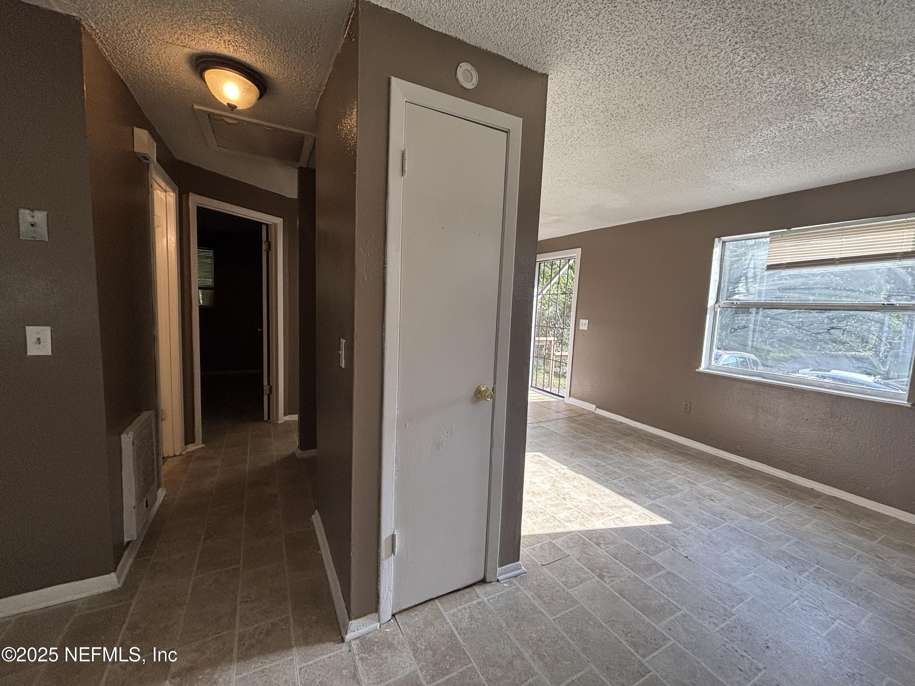 1115 Rushing Street Jacksonville, FL 32209 - Photo 6 of 24 a view of a hallway with wooden floor and windows