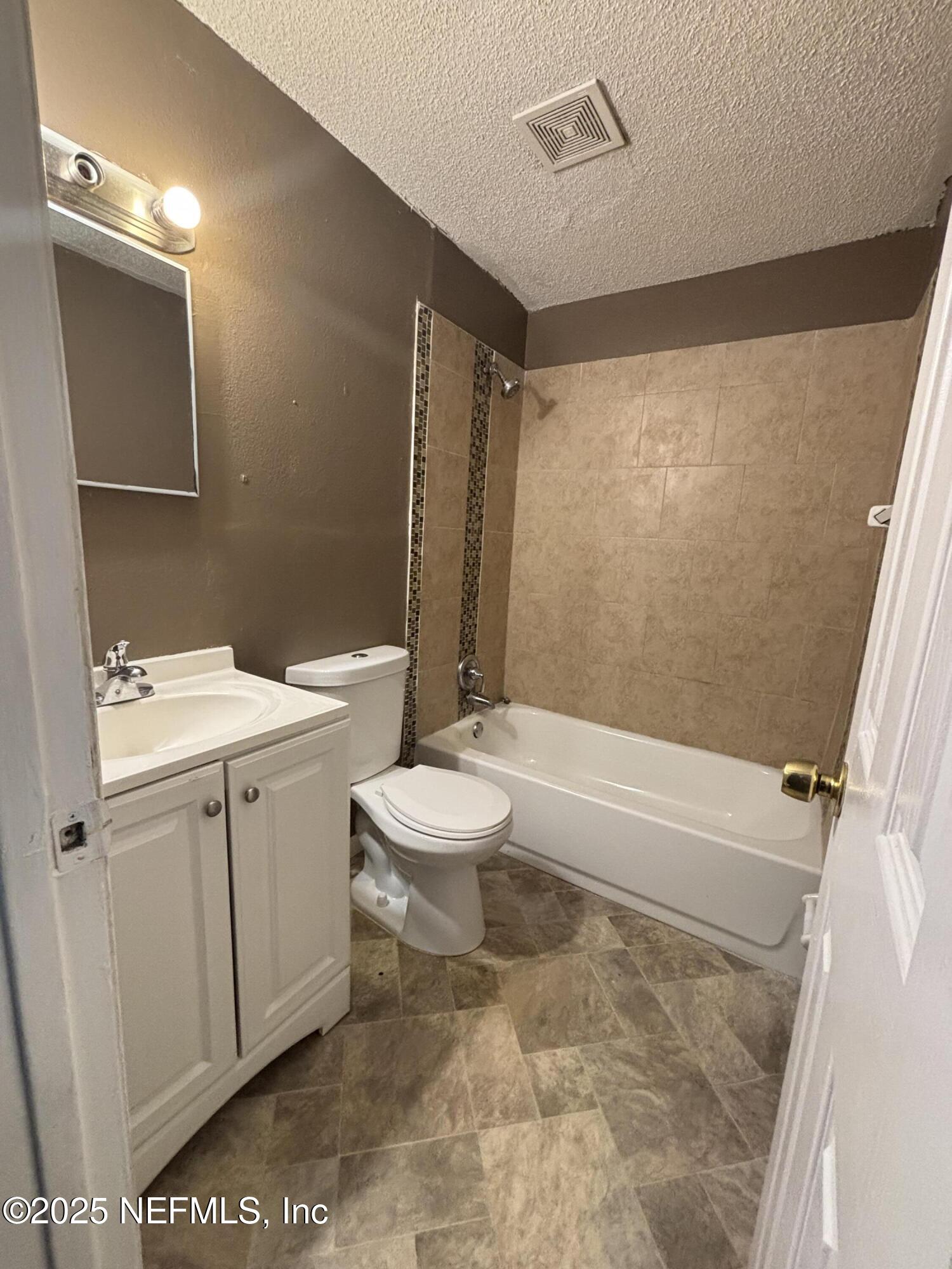 1115 Rushing Street Jacksonville, FL 32209 - Photo 9 of 24 a bathroom with a sink a toilet and shower