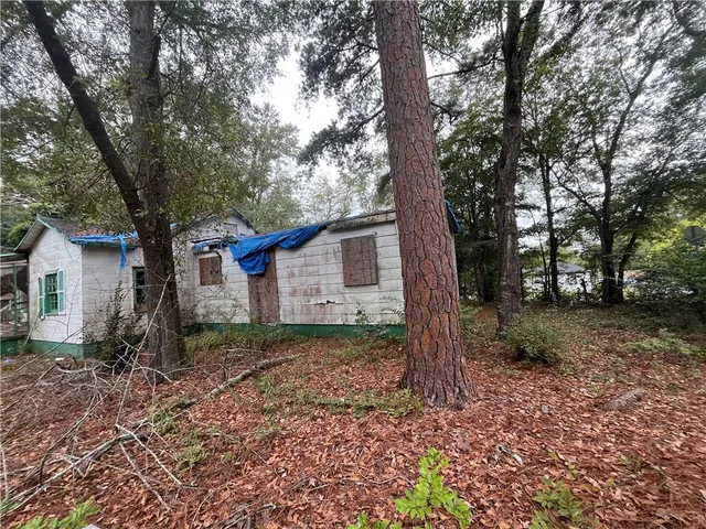 a view of a house with yard and a tree
