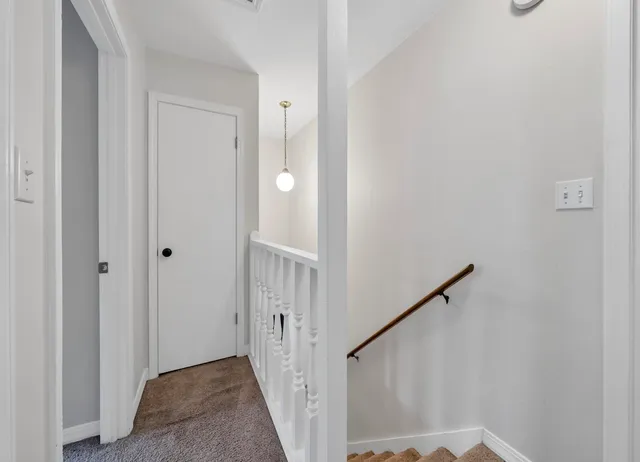 a view of a hallway with a door