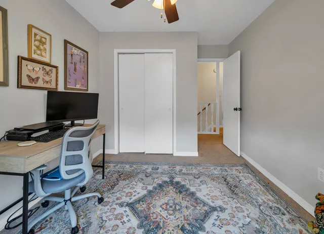 a view of a workspace with furniture and wooden floor