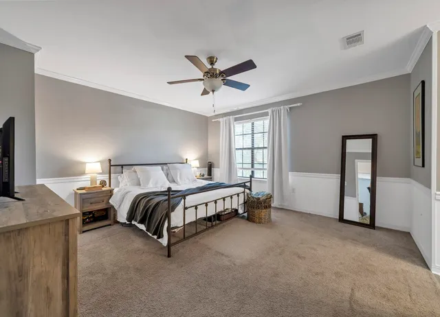 a spacious bedroom with a bed and a window