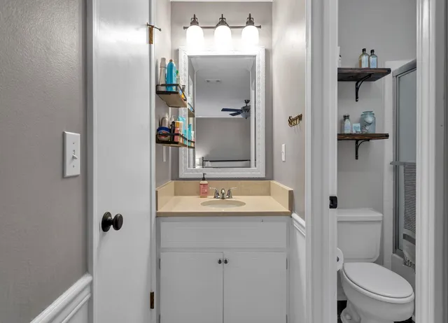a bathroom with a sink toilet and shower