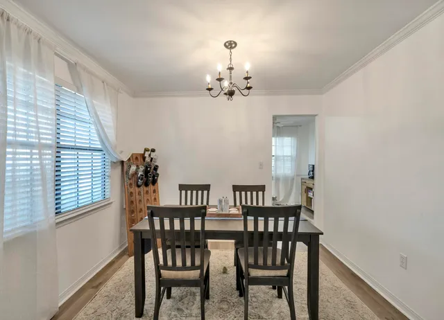 a view of a dining room with furniture and chandelier