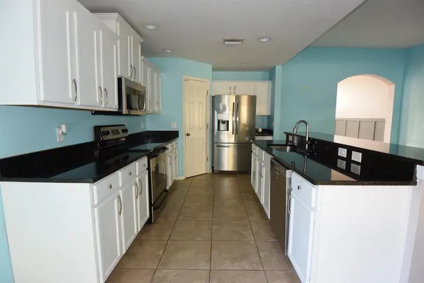 a kitchen with stainless steel appliances a sink and a microwave