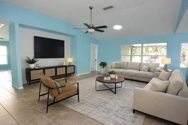 a living room with furniture and a flat screen tv