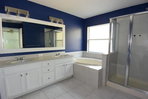 a bathroom with a bathtub sink and mirror