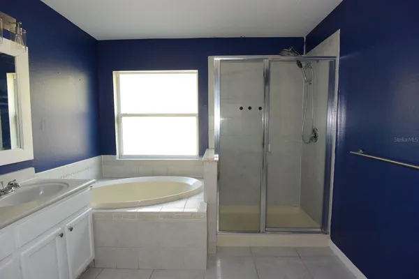a bathroom with a granite countertop sink a shower and a mirror