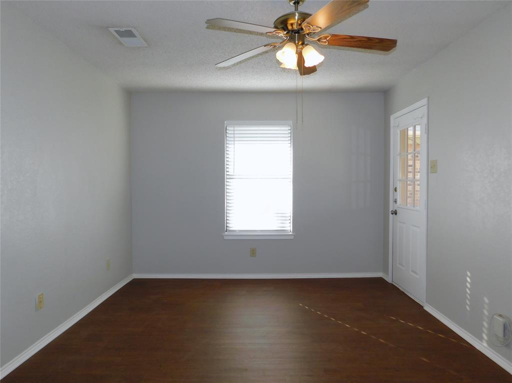 2214 Bernard Street Denton, TX 76205 - Photo 8 of 16 an empty room with a window and a fan