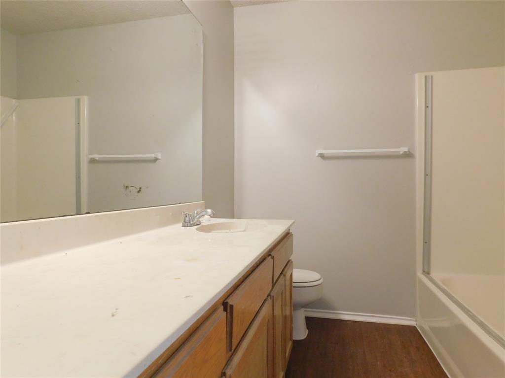 2214 Bernard Street Denton, TX 76205 - Photo 9 of 16 a bathroom with a sink a toilet and a shower